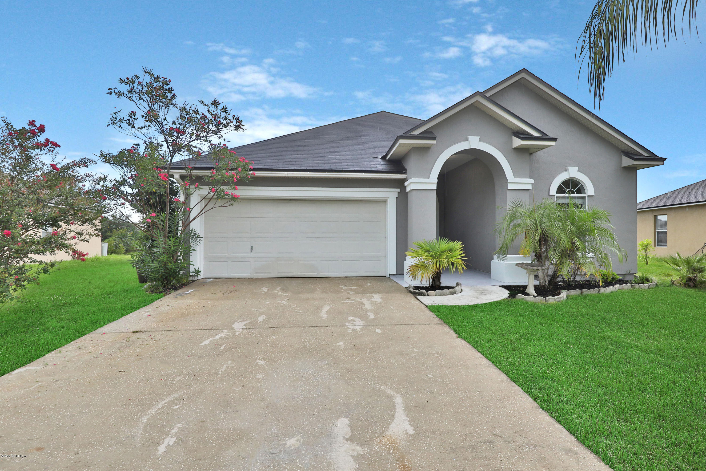 9189 Raptor Drive Jacksonville, FL 32221 - Photo 2 of 23 a front view of a house with garden