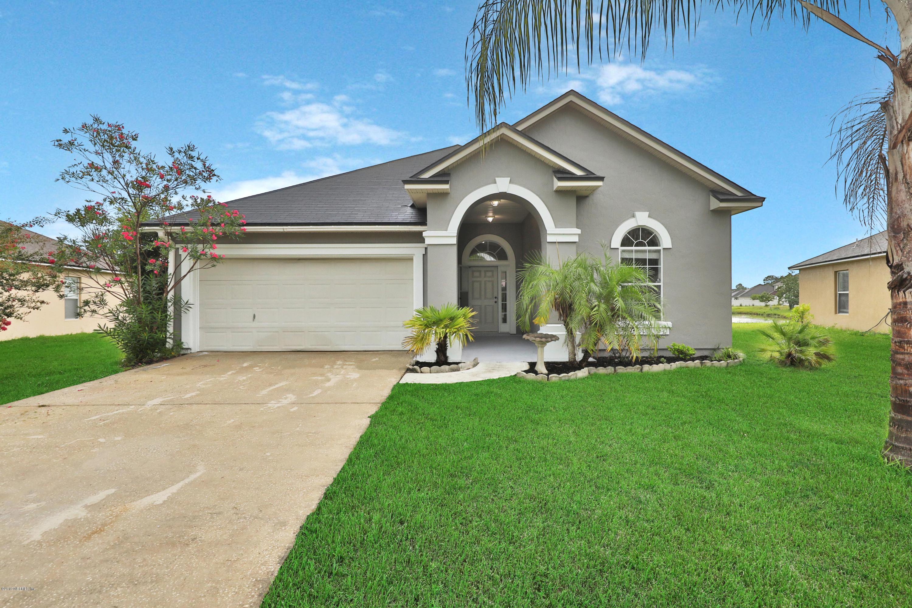 9189 Raptor Drive Jacksonville, FL 32221 - Photo 3 of 23 a front view of a house with a yard