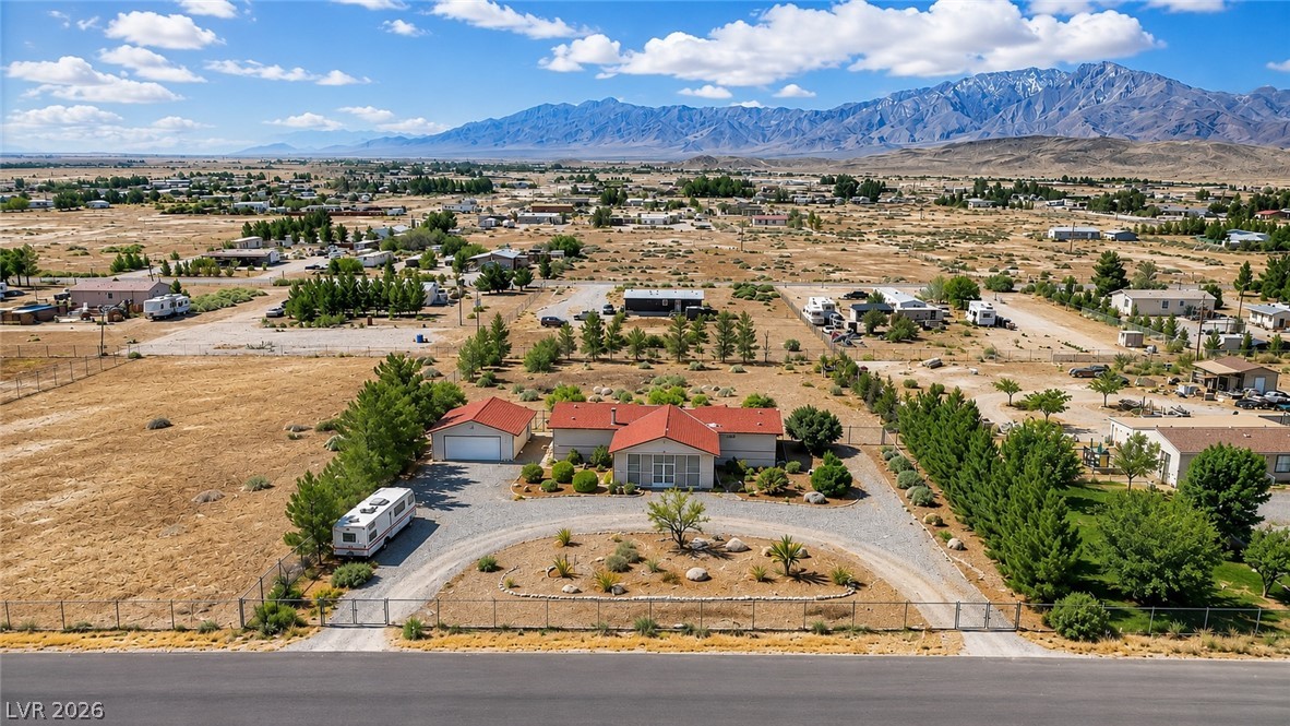 4361 Maple Road Pahrump, NV 89048 - Photo 1 of 35 A desert oasis with a single-level home, detached garage, and captivating mountain views.