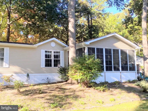 a front view of a house with a garden and plants