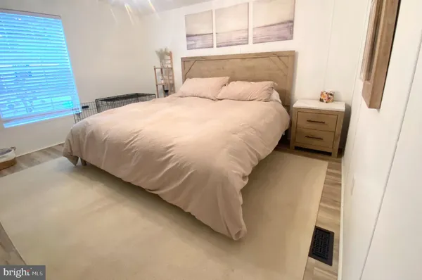 a large bed sitting in a bedroom next to a window