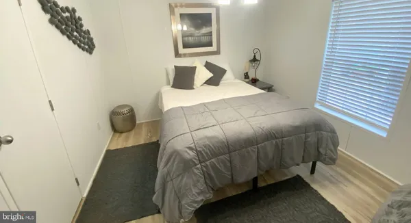 a bedroom with a bed and painting on the wall