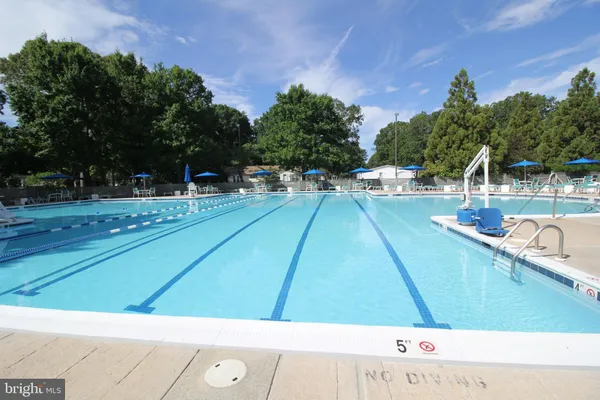 a view of a swimming pool with an outdoor seating