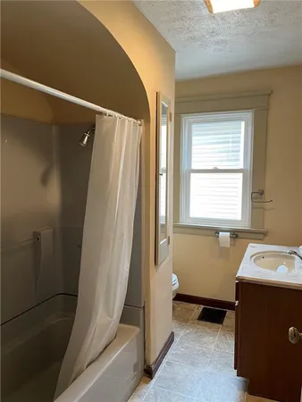 a bathroom with a bathtub and a window