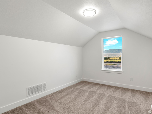 1267 West 2350 South Perry, UT 84302 - Photo 31 of 35 Room featuring sloped ceilings, a single window, and neutral-toned carpeting