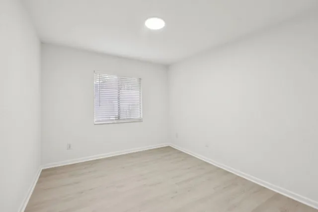 an empty room with a empty space and window