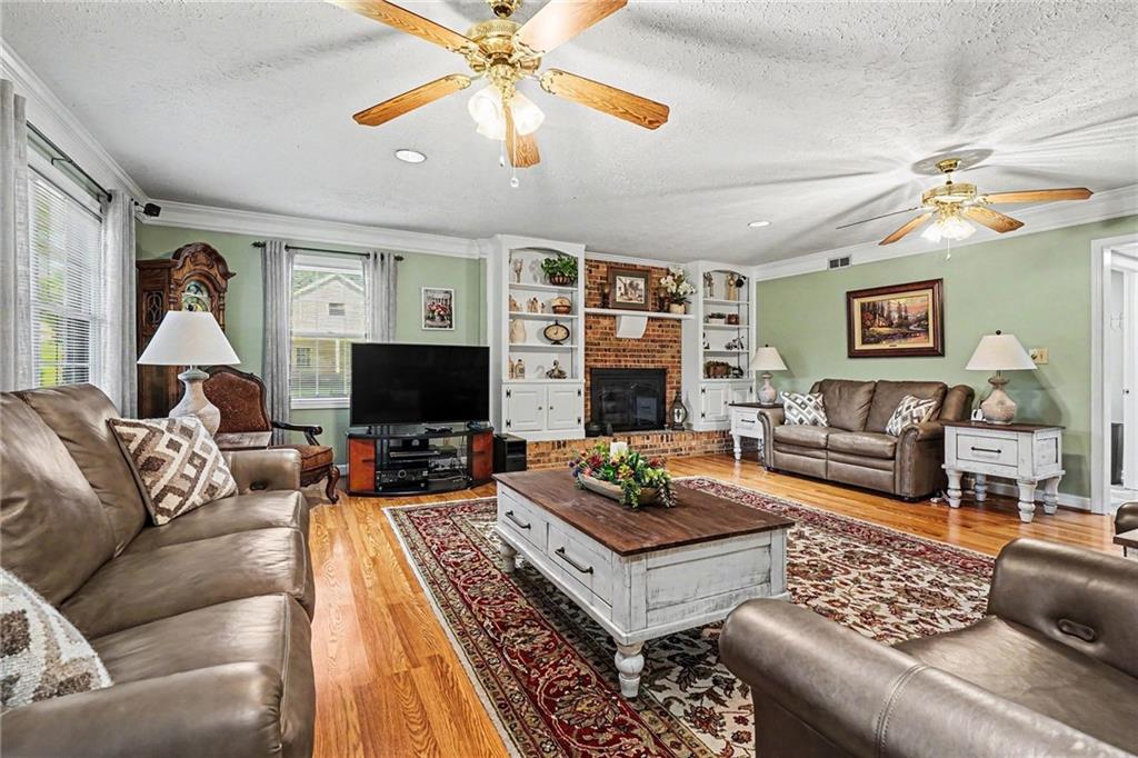 740 Smyrna Road Southwest Conyers, GA 30094 - Photo 6 of 27 a living room with furniture a flat screen tv and a fireplace