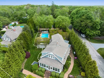 an aerial view of a house with a yard basket ball court and outdoor seating