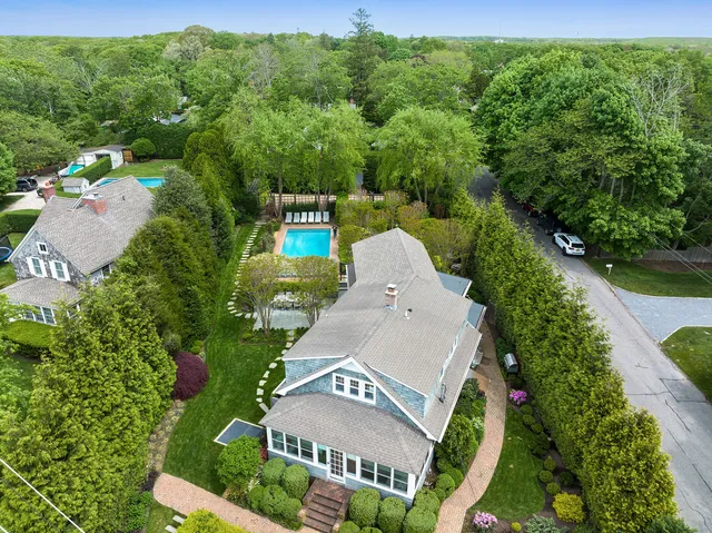 an aerial view of a house with a yard basket ball court and outdoor seating