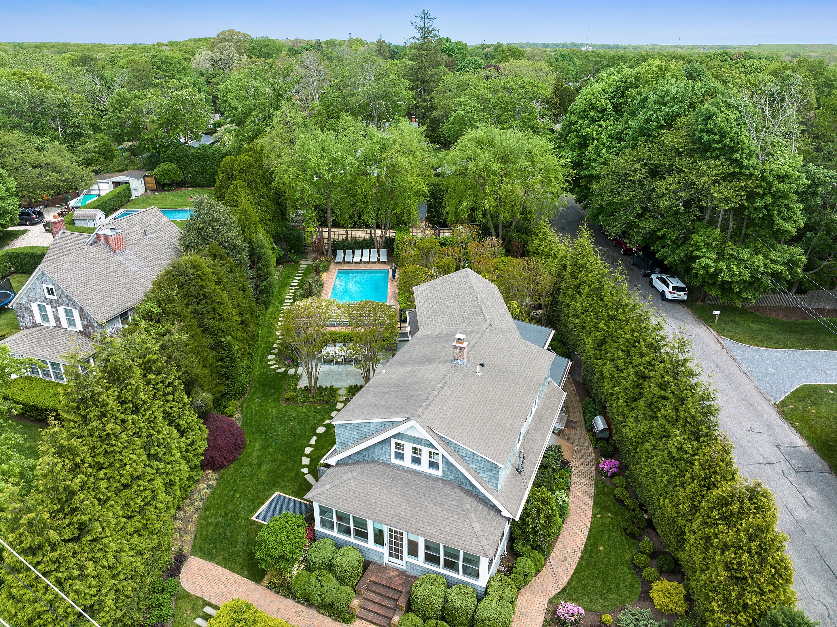 an aerial view of a house with a yard basket ball court and outdoor seating