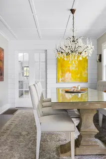 a dining room with furniture and chandelier
