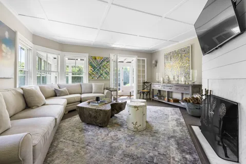 a living room with fireplace furniture and a flat screen tv