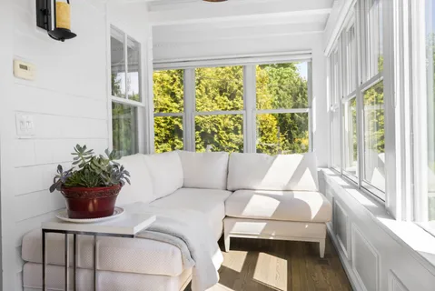 a living room with furniture and a potted plant