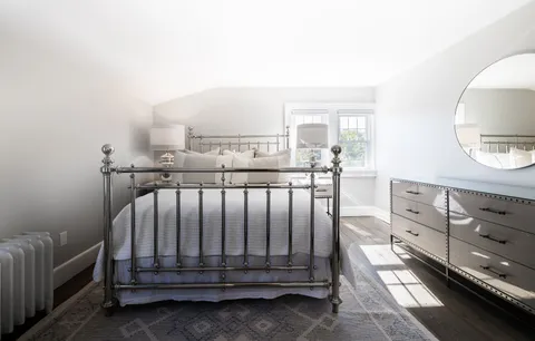 a view of a bedroom with furniture