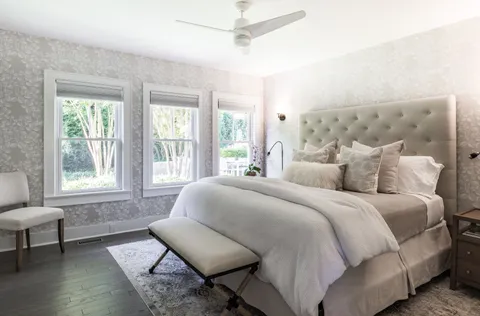 a spacious bedroom with a bed and a window