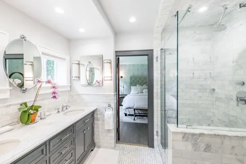 a bathroom with a granite countertop sink mirror and shower