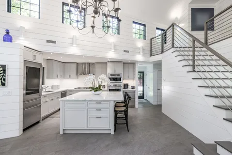 a kitchen with cabinets and window