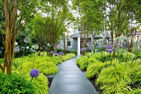 a view of a swimming pool with lawn chairs under an umbrella