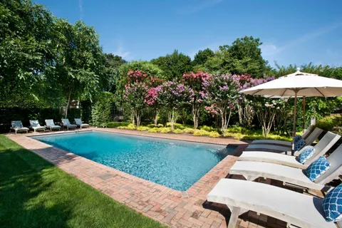 a view of a yard with chairs
