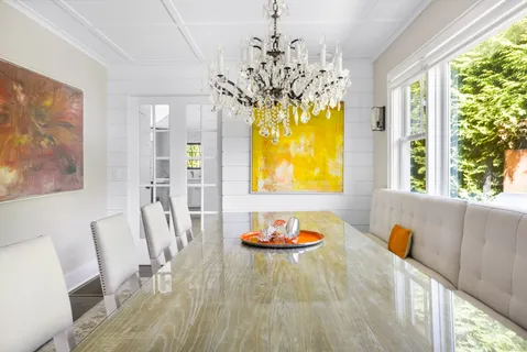 a view of a dining room with furniture and a chandelier