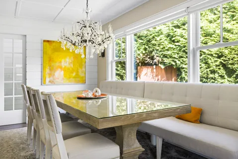 a dining room with furniture and window