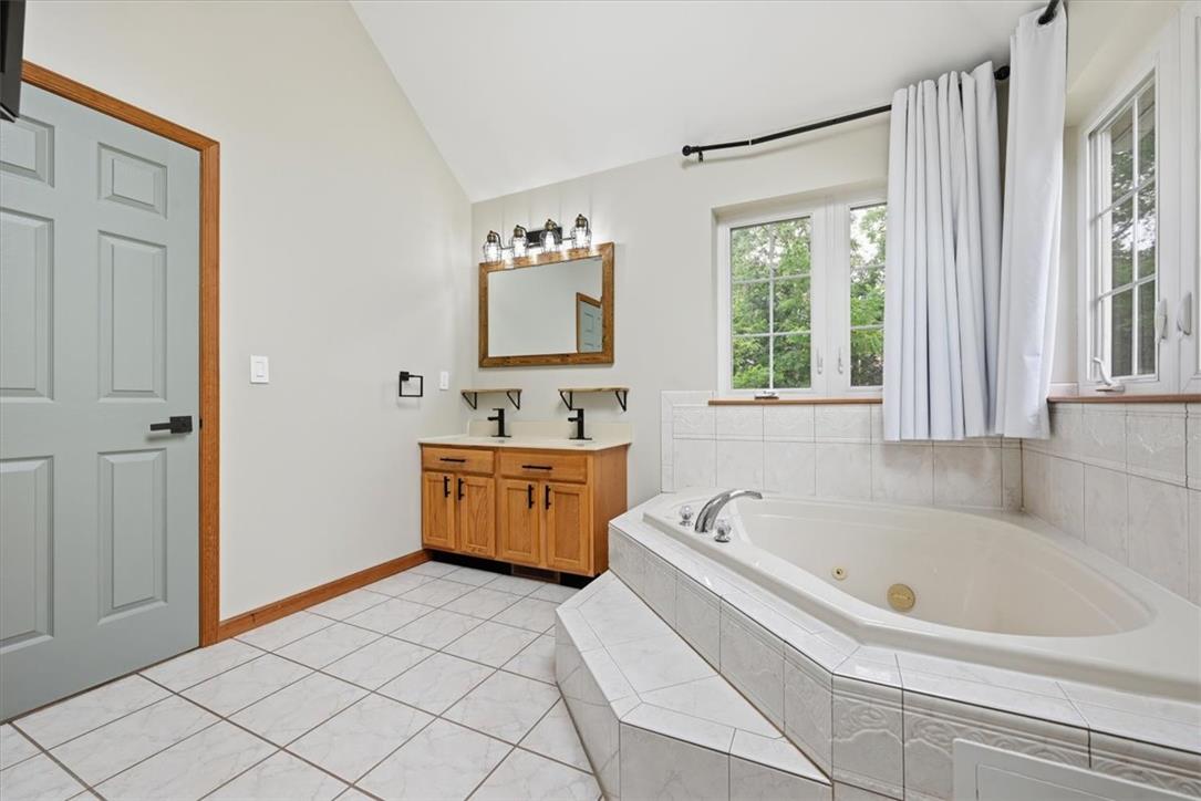 387 Blue Ridge Road Saylorsburg, PA 18353 - Photo 54 of 90 Indulge in a tranquil retreat featuring a spacious corner tub and double vanity, perfect for unwinding.