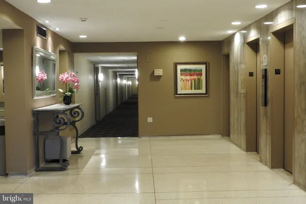 a very nice looking room with a large mirror and potted plants
