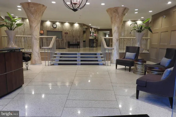 a lobby with furniture and a potted plant