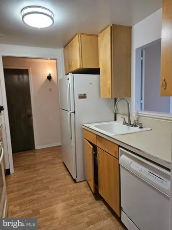 a kitchen with a sink appliances and cabinets