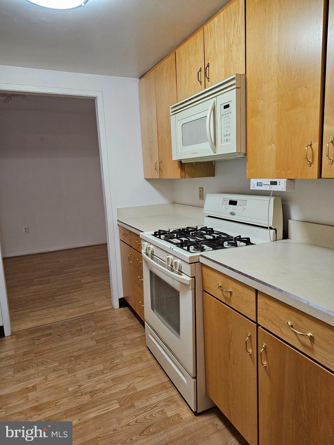 309 Florence Avenue, Unit 627N Jenkintown, PA 19046 - Photo 6 of 35 a kitchen with stainless steel appliances granite countertop a stove a sink and a microwave