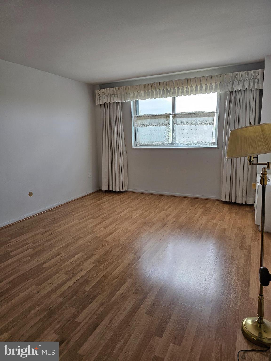 309 Florence Avenue, Unit 627N Jenkintown, PA 19046 - Photo 8 of 35 an empty room with wooden floor and windows