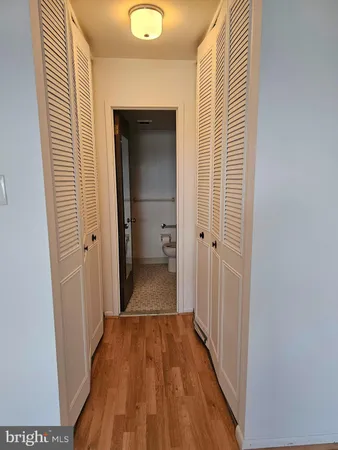 a view of a hallway with wooden floor
