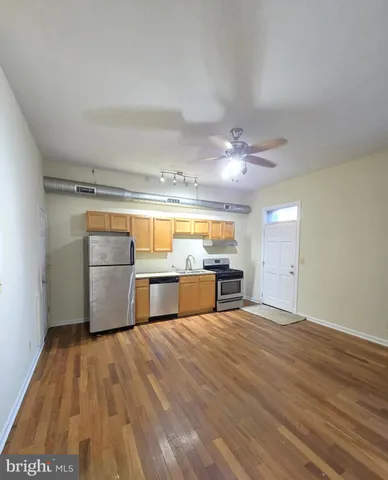a view of a kitchen with wooden floor