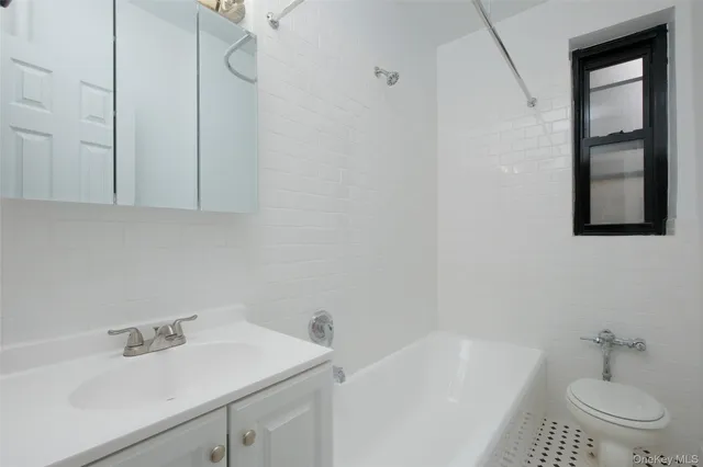 a bathroom with a sink toilet and tub