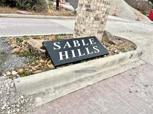 a view of a wooden bench under a large building