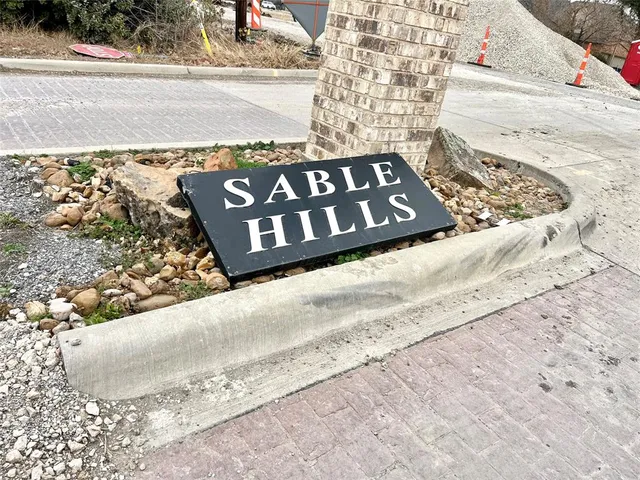 a view of a wooden bench under a large building