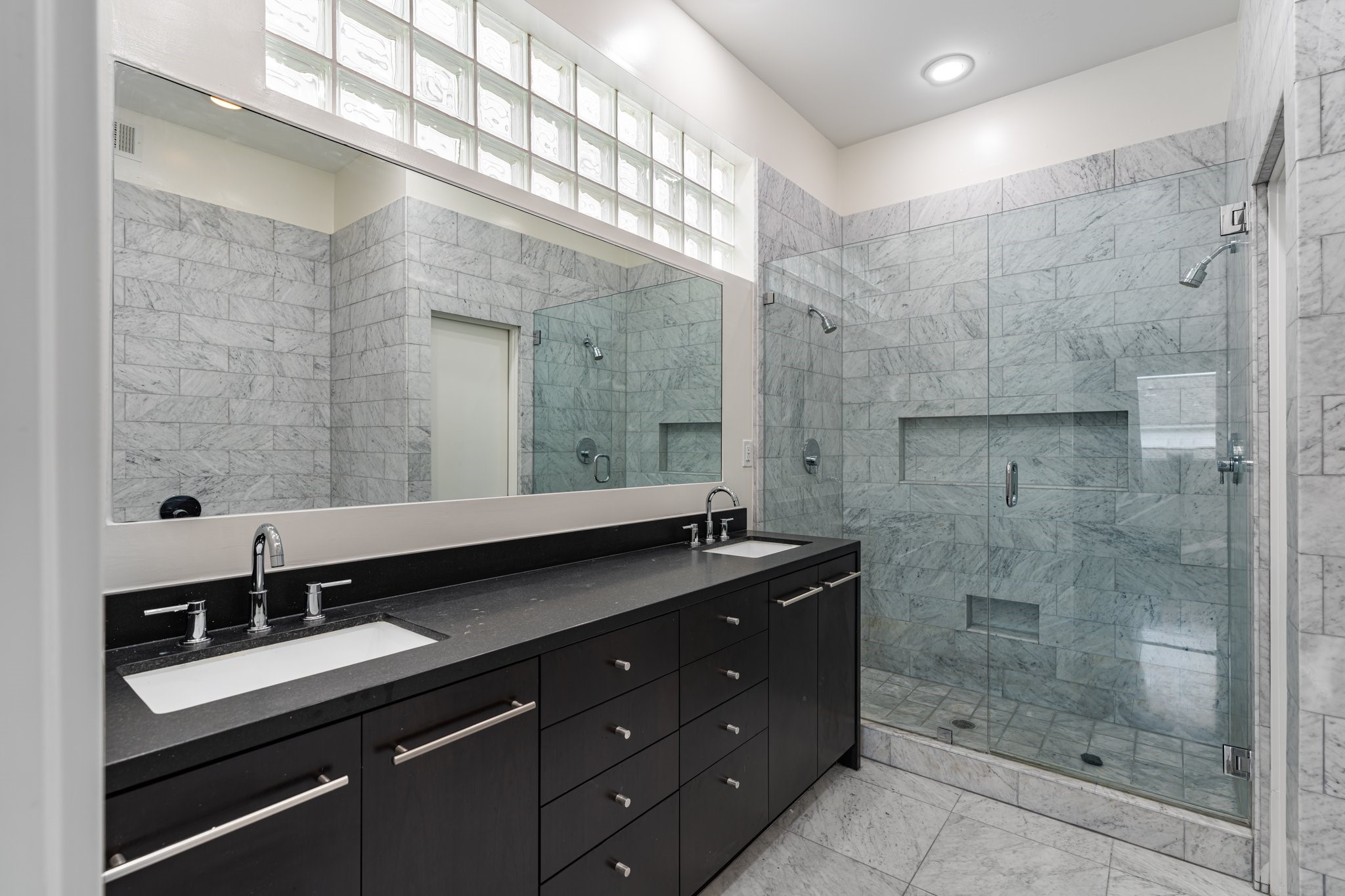 1728 Michigan Street, Unit B Houston, TX 77006 - Photo 13 of 24 The spacious primary bath features carrara marble, double sinks and plenty of vanity storage.