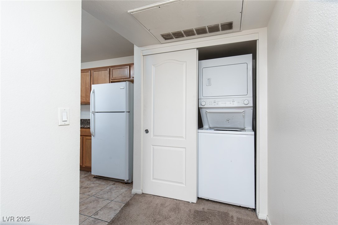 7720 Secret Shore Drive, Unit 207 Las Vegas, NV 89128 - Photo 15 of 21 Washer and dryer (stacked) stay with the property.