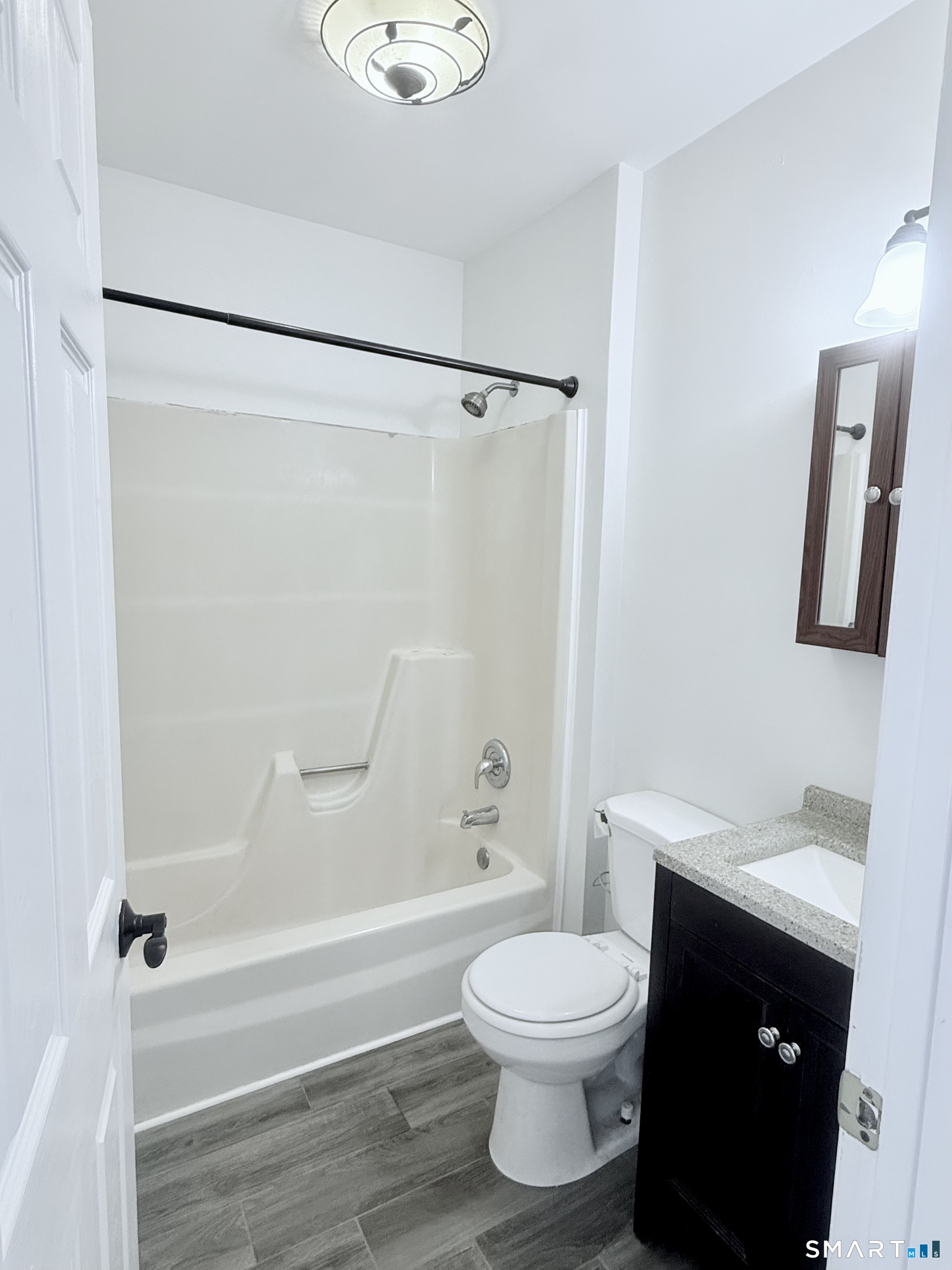 175 Mill Pond Road, Unit 106 Hamden, CT 06514 - Photo 18 of 22 a bathroom with a toilet and a bathtub