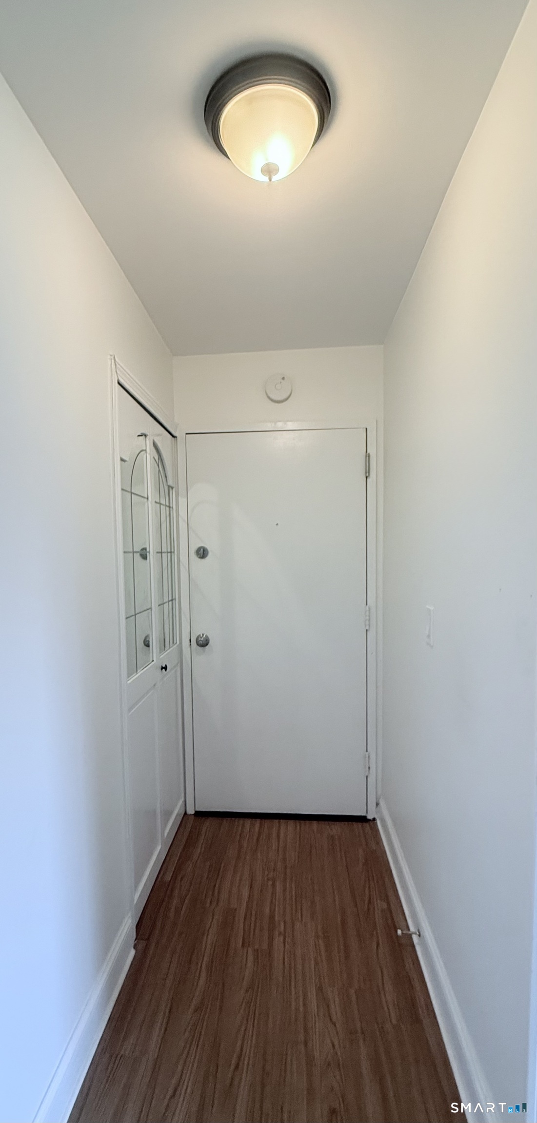 175 Mill Pond Road, Unit 106 Hamden, CT 06514 - Photo 2 of 22 a view of a room with wooden floor and a window