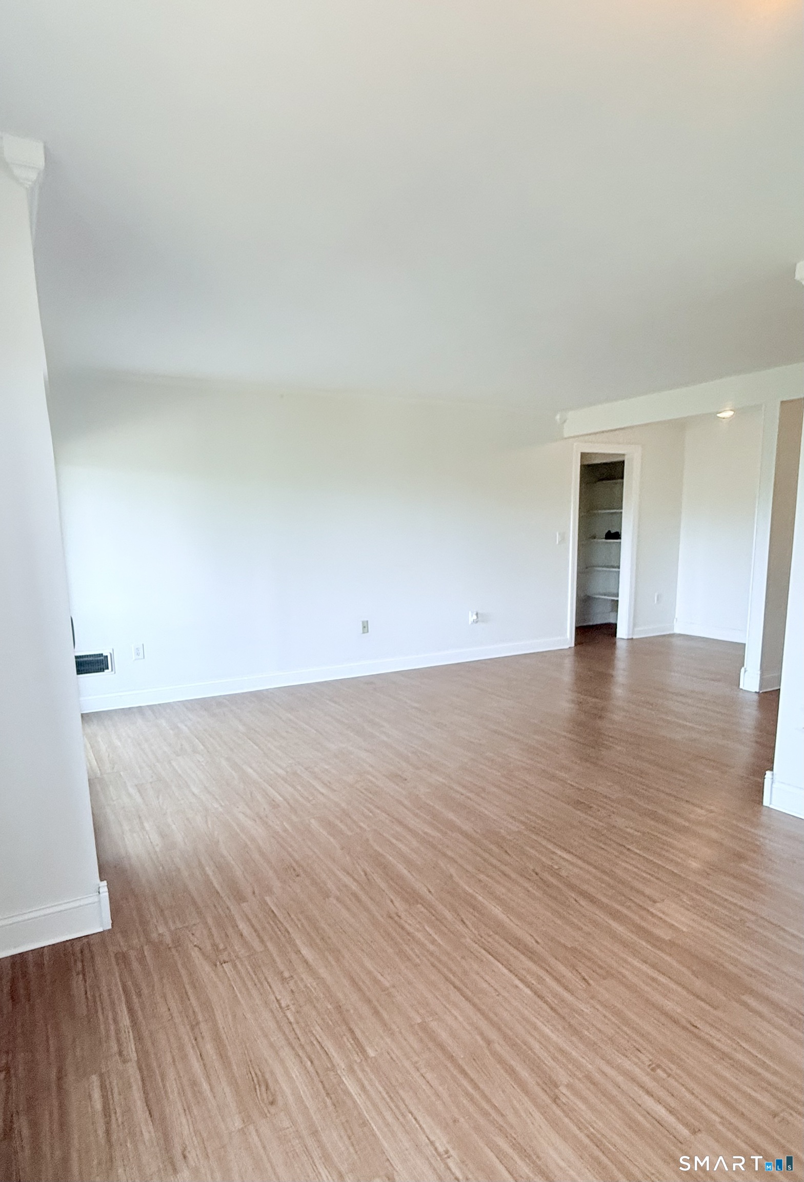 175 Mill Pond Road, Unit 106 Hamden, CT 06514 - Photo 6 of 22 a view of an empty room and wooden floor