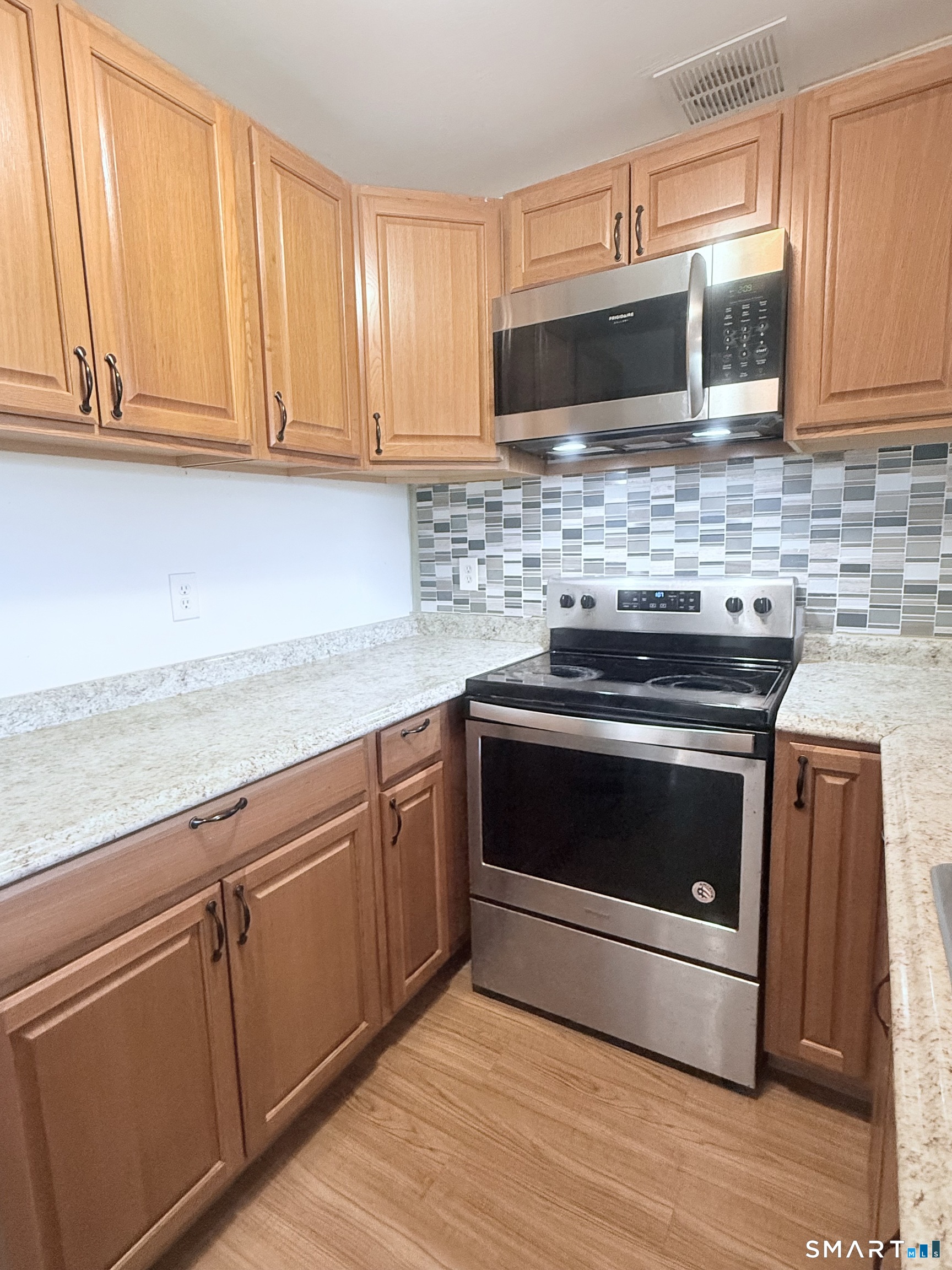 175 Mill Pond Road, Unit 106 Hamden, CT 06514 - Photo 9 of 22 a kitchen with granite countertop stainless steel appliances and cabinets