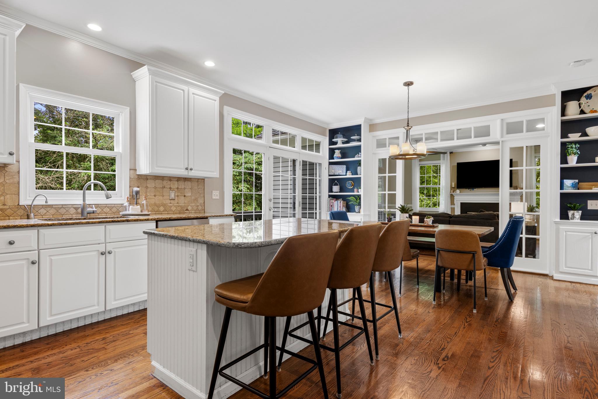 427 Buttonwood Road Landenberg, PA 19350 - Photo 33 of 82 a kitchen with stainless steel appliances granite countertop a stove top oven a sink dishwasher and a dining table with wooden floor