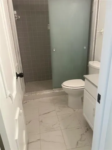 a white toilet sitting next to a bathroom sink