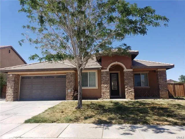 a front view of a house with yard