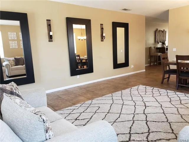 a bedroom with a bed and a mirror on dresser
