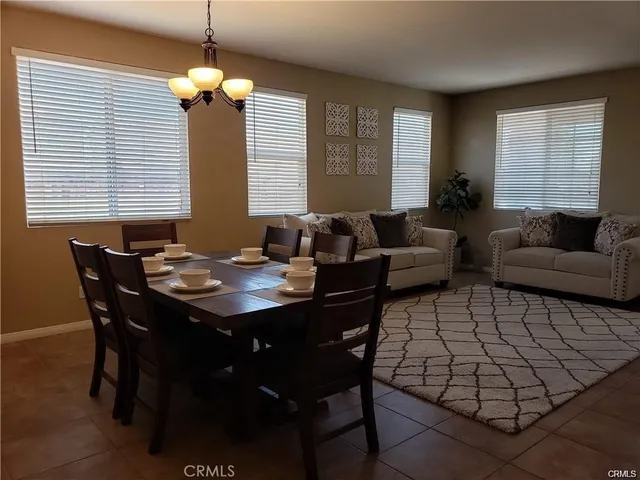 a living room with furniture a window and a chandelier