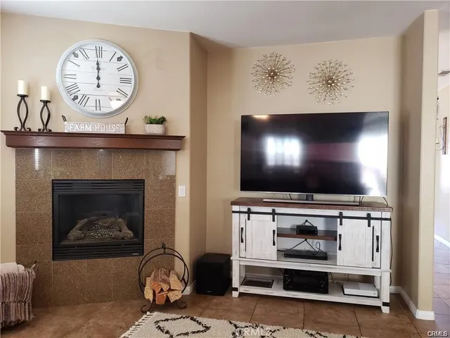 a living room with a fireplace and a flat screen tv