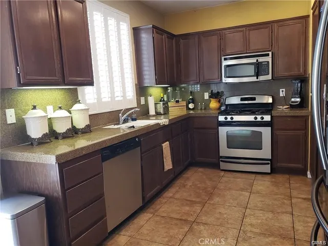 a kitchen with a sink stove and microwave