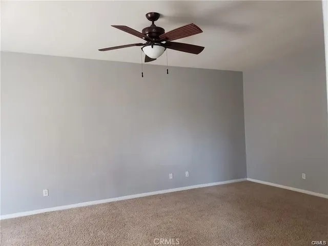 a view of a room with a ceiling fan